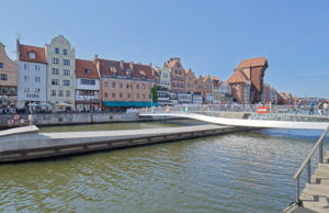 Prominent waterfront in Gdańsk, Poland, featuring modern infrastructure alongside historic architecture